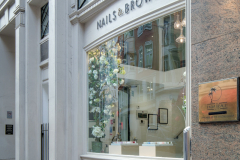 Image of nail salon, taken from outside looking through the shop glass