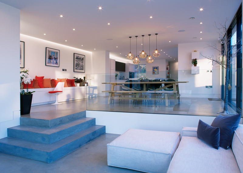 Sunken family area with three concrete steps up to breakfast area & kitchen