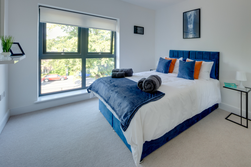 double bedroom with view out through a large window