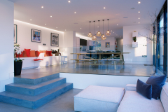 Sunken family area with three concrete steps up to breakfast area & kitchen